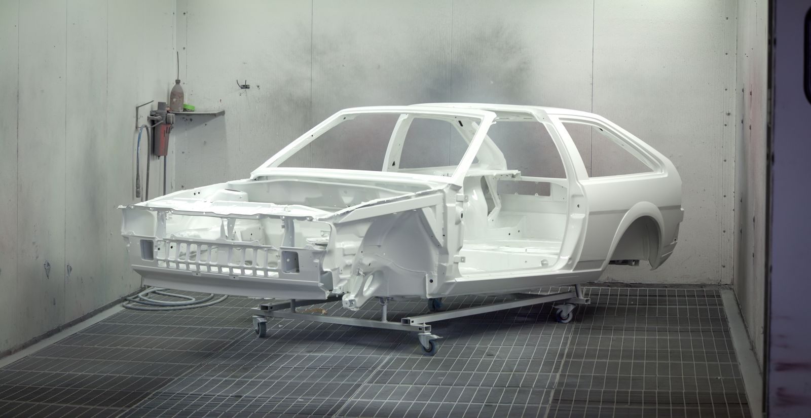 A car shell stripped back to bare metal, mid-restoration